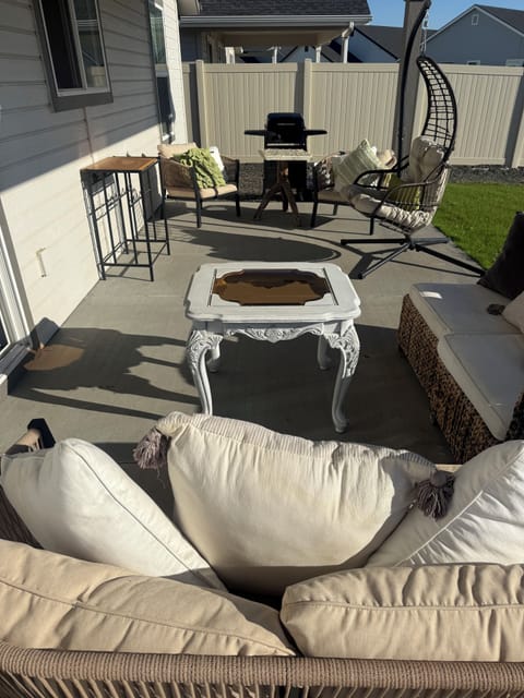 Cozy outdoor seating, sweet chair & grill—perfect for relaxing & grilling fun!