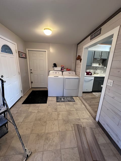 Washer and dryer conveniently located by garage entry and kitchen.