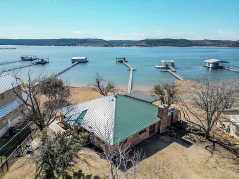 Charming lake house with direct access to Possum Kingdom Lake, featuring private docks and stunning water views. Perfect for a tranquil getaway.