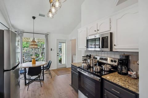 Enjoy cooking and gathering in the open, bright, newly renovated kitchen—complete with lovely views of the back patio for a warm and inviting touch.