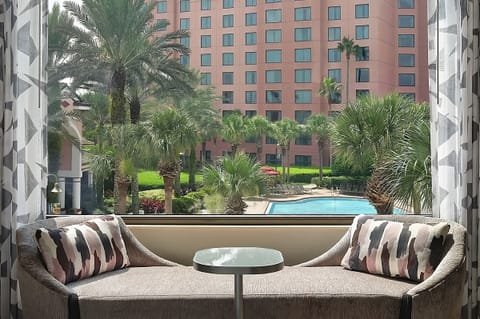 Sip coffee by the window overlooking palms and the pool.