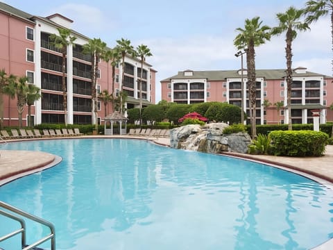 Float peacefully in a quieter pool courtyard framed by palms.