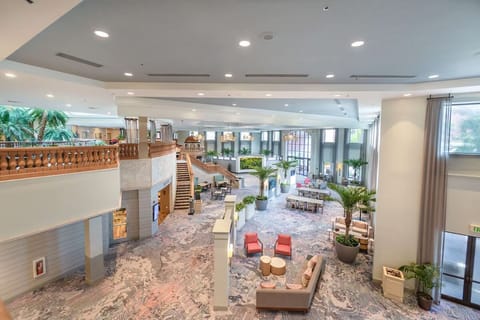 Unwind in the airy atrium lounge surrounded by palms.