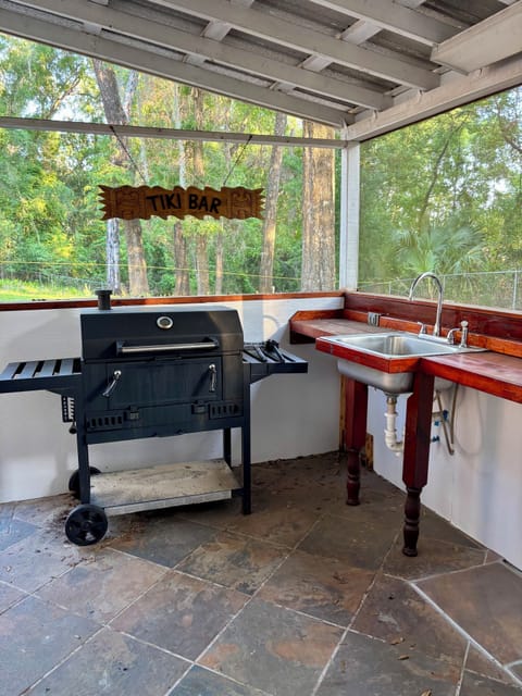 Charcoal BBQ grill, outdoor bar area w/ sink & half bath