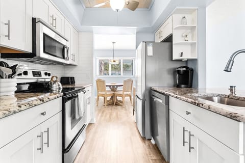 Enjoy ample cabinetry and generous counter space, making meal prep easy and organized in this functional kitchen