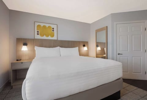 Sink into a king bed with calming, modern warmth.
