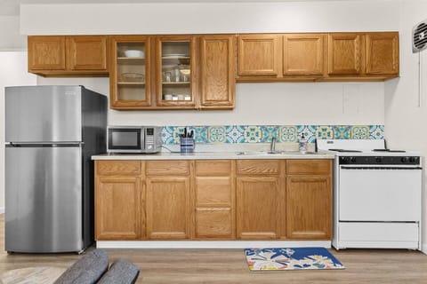 Fridge, microwave, sink, oven, stove, and basic kitchen utensils