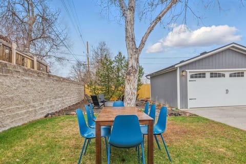 Large backyard with fire pit, dining table, and yard games