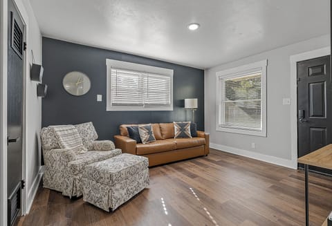 Living Room with Couch and swivel chair with ottoman, Roku TV, Games