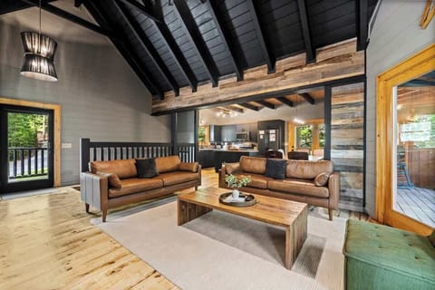 A modern luxury cabin seamlessly blending rustic elegance with high-end finishes, surrounded by breathtaking treetop views in the heart of the Smoky Mountains.  This is Modern Rustic Hideaway.