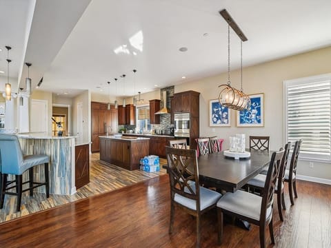 Experience culinary bliss in this modern kitchen with top-of-the-line appliances, abundant cabinetry, and a spacious open layout perfect for entertaining.