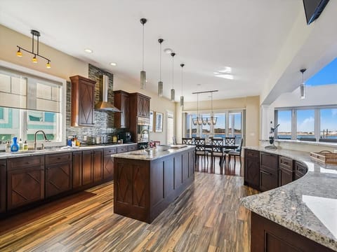 This stunning modern kitchen features luxurious amenities, spacious countertops, and captivating bayfront views, making it a perfect space for culinary enthusiasts.