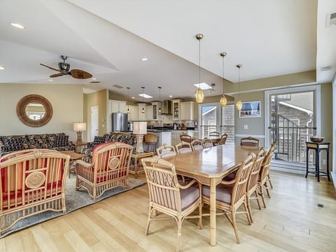 An inviting open-concept living and dining area, showcasing comfortable seating, elegant decor, and connections to the kitchen, all bathed in natural light.