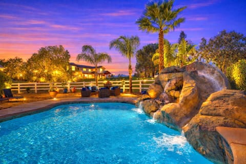 Another angle of the backyard pool with a miniature slide for fun!