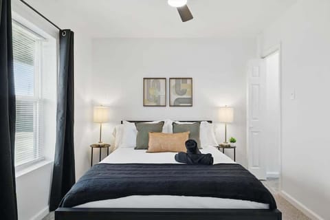 “Second Queen Bedroom in Unit 2 with Natural Light” This serene queen bedroom features soft lighting, cozy linens, and blackout curtains — ideal for a peaceful night’s sleep or a lazy morning in.