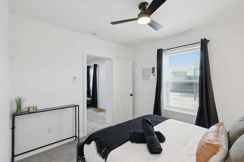 “Cozy Queen Bedroom with Workspace” Unwind in a comfy queen bed with blackout curtains and stylish touches. This room also features a small desk, closet, and plenty of natural light — perfect for work or rest.