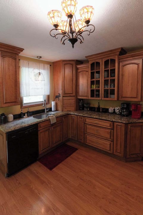 Kitchen: Culinary adventures await in this elegant space with rich cabinetry and modern amenities!