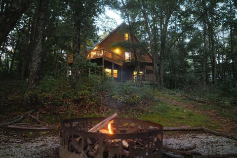 Exterior: Embrace nature from this charming cabin, complete with a fire pit and serene woodland views!
