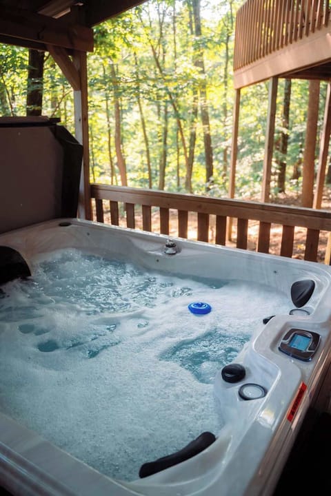 Hot Tub Retreat: Unwind in bubbling bliss surrounded by serene woodland views!