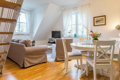 Bright Living Room with Sofa and Dining Table