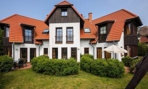 Exterior view of a stylish holiday home with red tiles