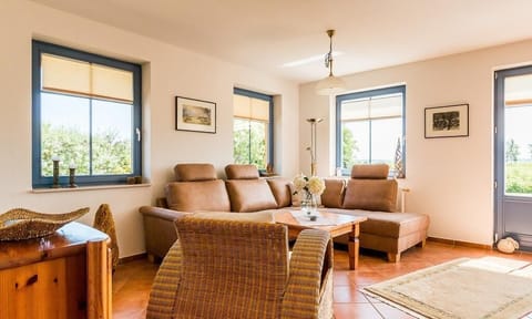 Bright living room with sofa and armchairs