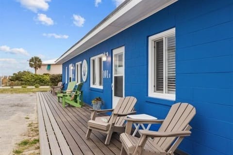 Relax on your private deck with comfortable Adirondack chairs, soaking up coastal vibes outside your charming blue cottage.