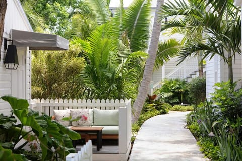 Sink into the tucked-away bench and breathe tropical air.