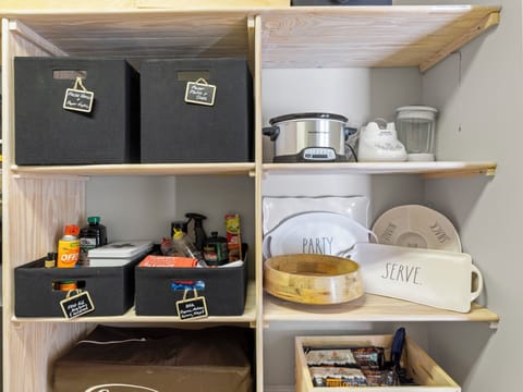 Pantry stocked with all the essentials, from spices to snacks to BBQ supplies.