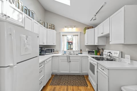 The kitchen is full of counter space and storage, making meal prep a breeze.