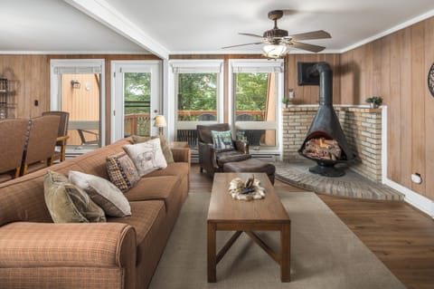 Cozy living room with fireplace, seating, and deck access.
