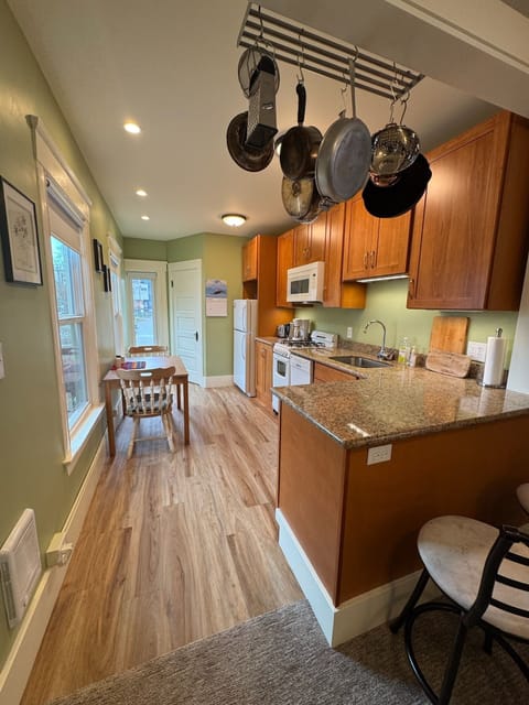 Kitchen, from the living room. Door to the bathroom at the far end.
