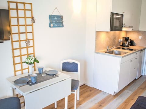 Furniture, Interior Design, Flooring, Wood, Floor, Kitchen, Room, Cabinetry, Countertop, Lighting