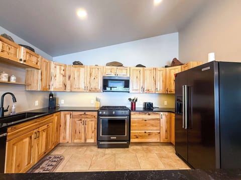 Full kitchen with gas range, dishwasher, microwave and refrigerator/freezer