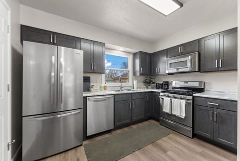 Cook up your favorite meals in this sleek, updated kitchen featuring stainless steel appliances