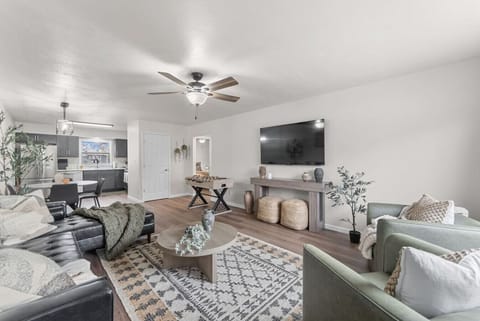 Main Living Room View (with kitchen) 🛋️ Open-concept living with cozy seating, large TV, and foosball fun!