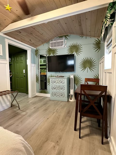 Studio style room combines the queen bed, entertainment center, and dining area.