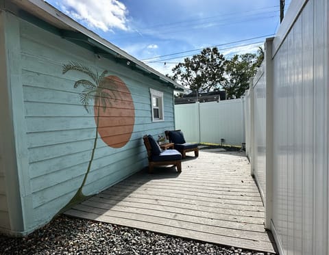 Private patio area with comfortable outdoor seating and string lights.