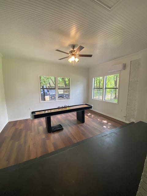 Gameroom with shuffle board. Awaiting the pool table