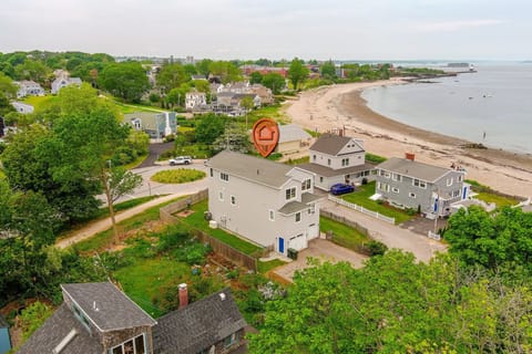 Charming beach home with ocean views and lush greenery.