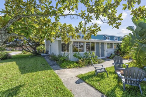 Sunny lawn surrounded by leafy trees—room to play, picnic, or let pups roam