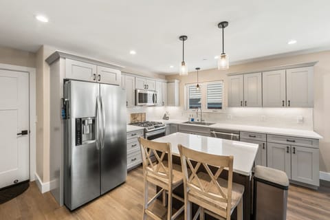 Spacious and well equipped kitchen with gas range and island for food prep