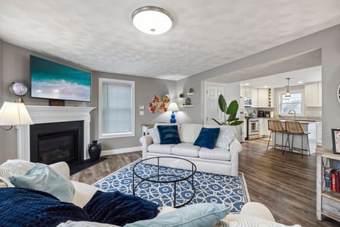 Cozy living room with a Smart TV, gas fireplace, and two comfy couches for a relaxing stay.