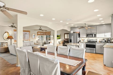 Chef’s kitchen stocked with premium appliances and cookware, plus dining seating for 8—perfect for shared meals and easy cooking.