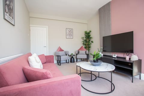 The sitting room offers a cozy and welcoming space to relax, complete with a comfortable sofa and a smart TV for your favourite shows. It’s the perfect spot to unwind after exploring the area.