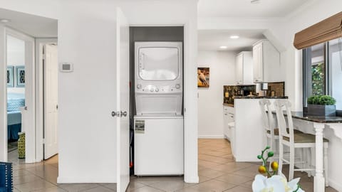 Convenient in-unit washer and dryer tucked away behind folding doors—perfect for keeping your beachwear and vacation essentials fresh throughout your stay.