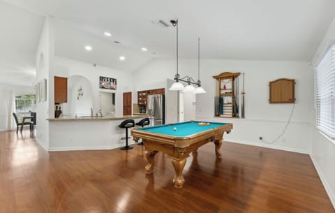 The game room has a stylish pool table and a dart board for hours of fun.