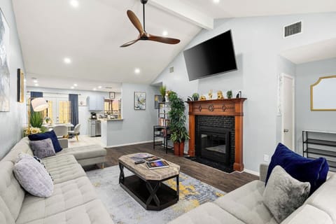 Relax and enjoy the wall-mounted TV from the comfortable sectional in this bright, open-concept space.