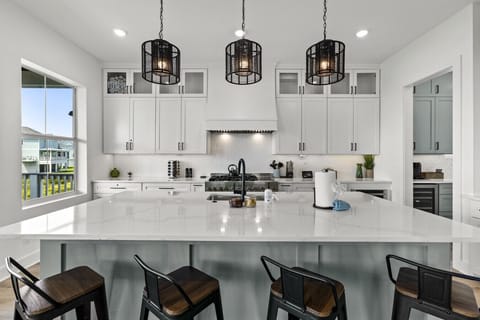 The heart of the kitchen — a bright, roomy island with bar stools and lots of space to relax or connect while cooking