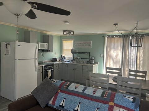 LIVING ROOM: Another view of the living room with the kitchenette and dining area in the background